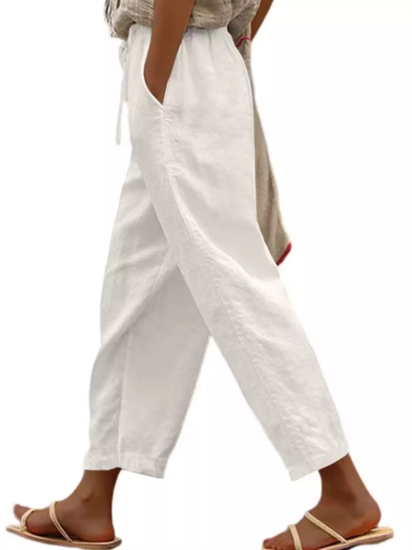 White cropped drawstring pants with side pockets, relaxed wide-leg fit