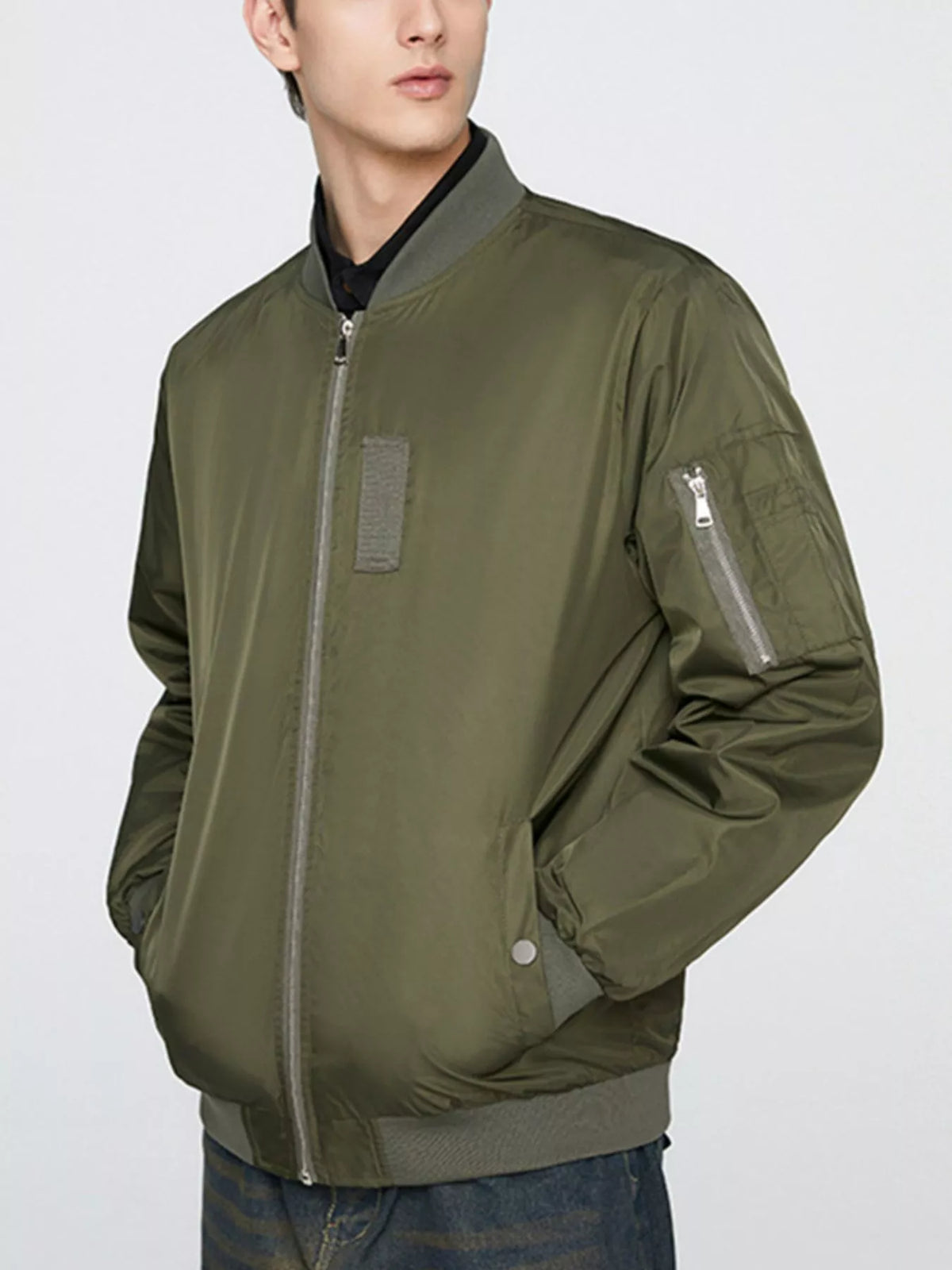 Army green bomber jacket with front zip and side utility pocket on the sleeve