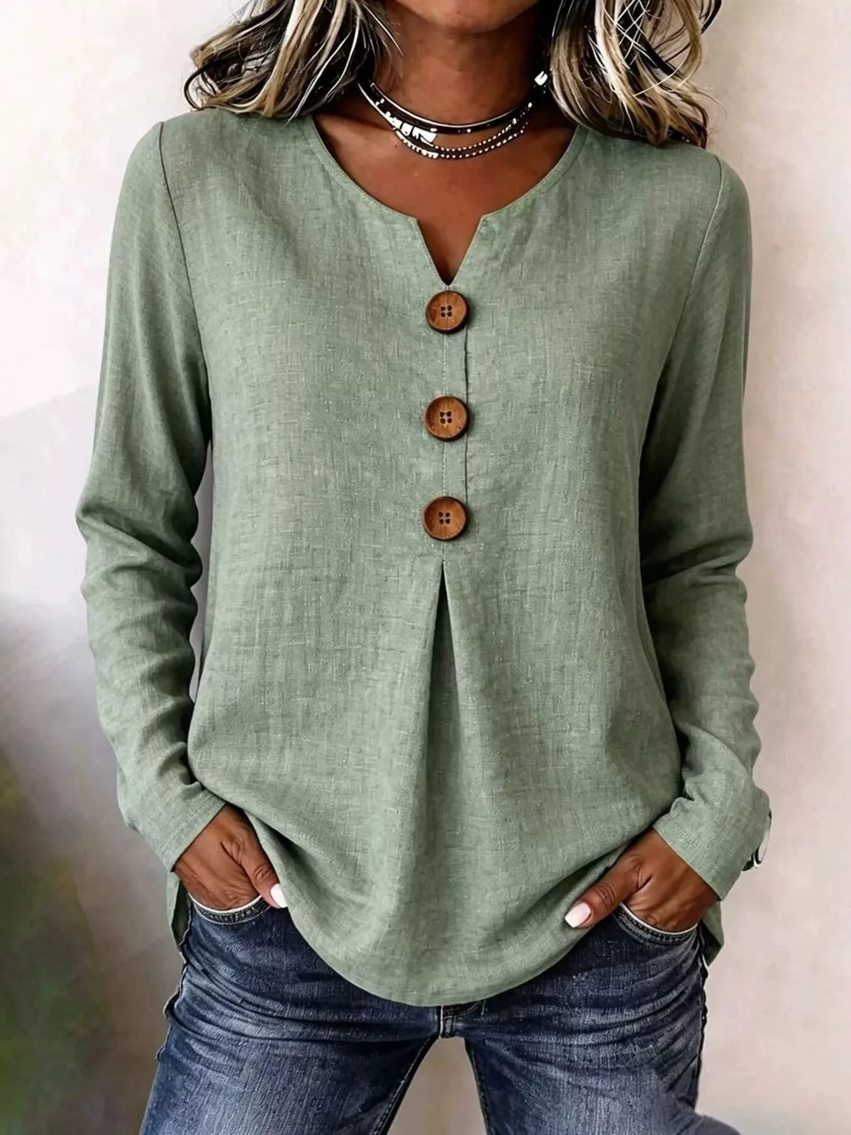Green long sleeve blouse with V-neck and decorative center button placket