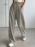 Striped elastic waist drawstring pants in black and white, side view full length