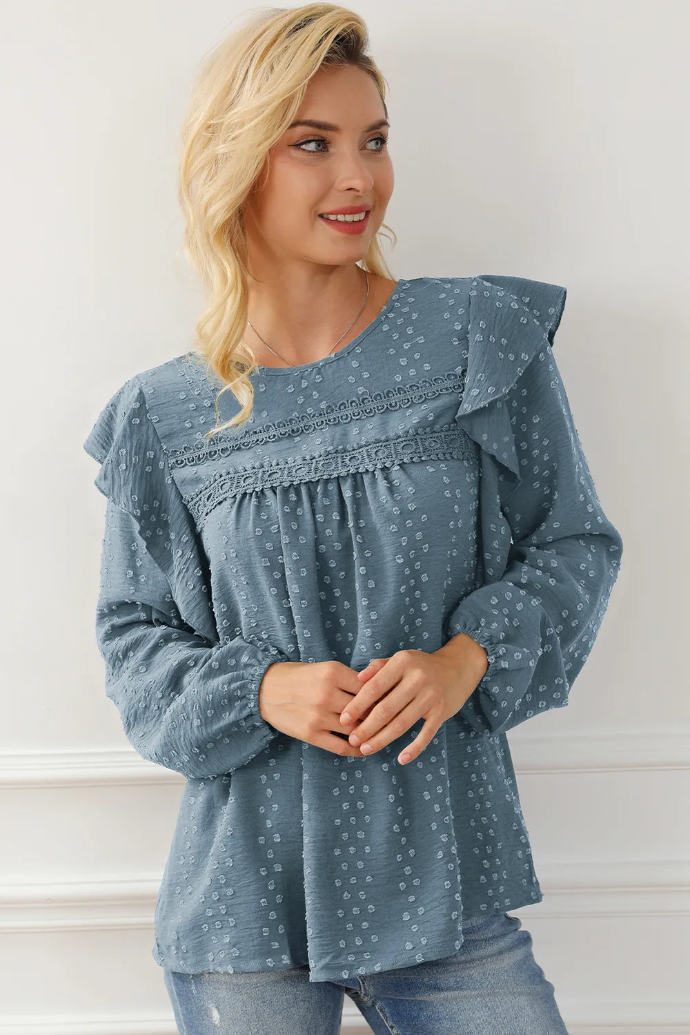 Blue round-neck ruffled blouse with voluminous sleeves and gathered yoke seam