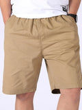 Men's plus-size tan pocketed shorts with zip fly, belt loops, and side pockets