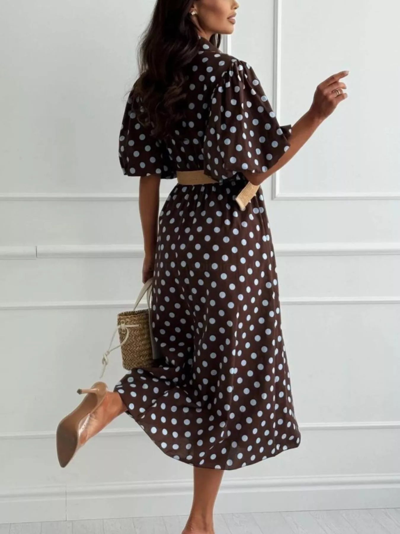 Dark brown polka-dot midi dress with puff sleeves, button front, and tan waist belt.