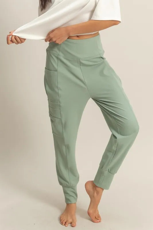 Sage green jogger sweatpants with side pocket seam and tapered ankle cuffs