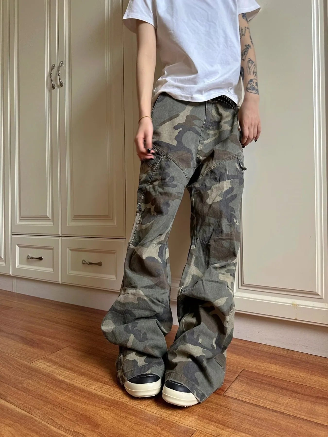 Green camouflage cargo jeans with flap cargo pockets and wide straight legs