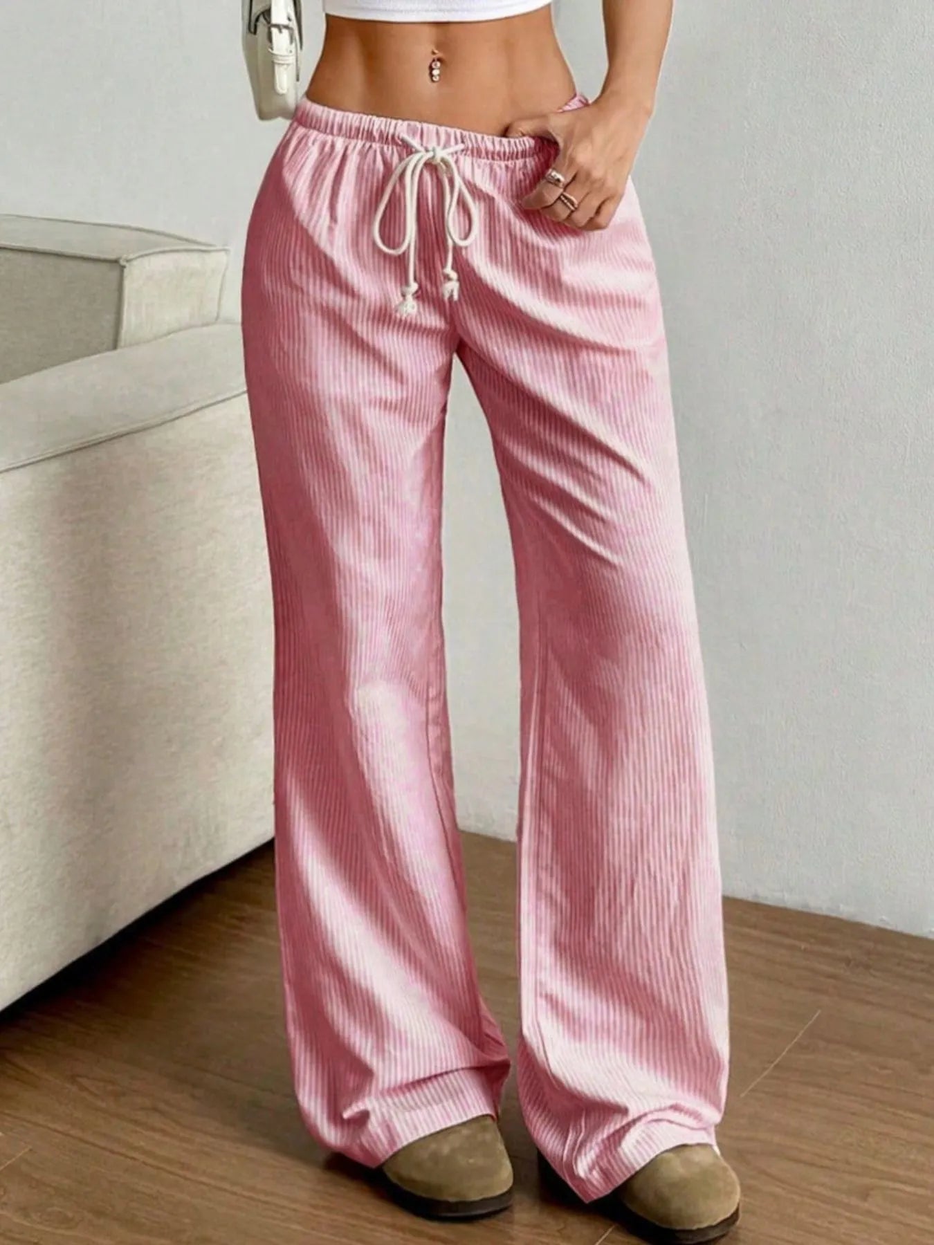 Pink striped wide-leg pants with elastic waistband and white drawstring with tassels