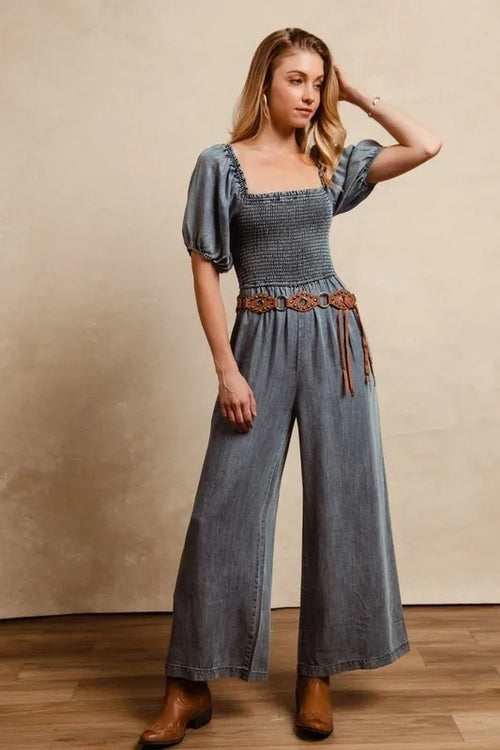 Denim jumpsuit with square neck, smocked top and puff sleeves, wide flared legs