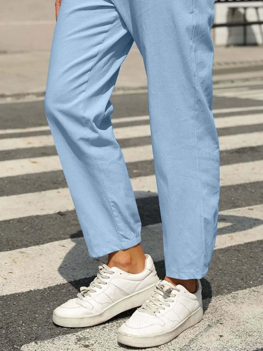 Light blue tapered elastic-waist pants with cuffed hem and front drawstring