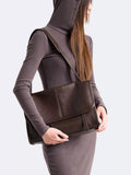 Brown vegan leather medium messenger bag with adjustable shoulder strap and flap pocket