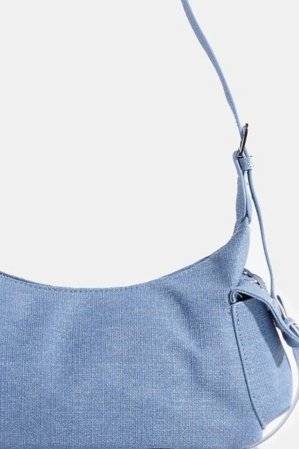 Dusty blue shoulder bag close-up with side pocket detail and strap attachment loops