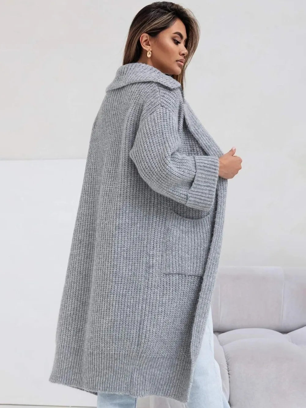 Gray knit cardigan with collared neck, dropped shoulders, and front patch pockets