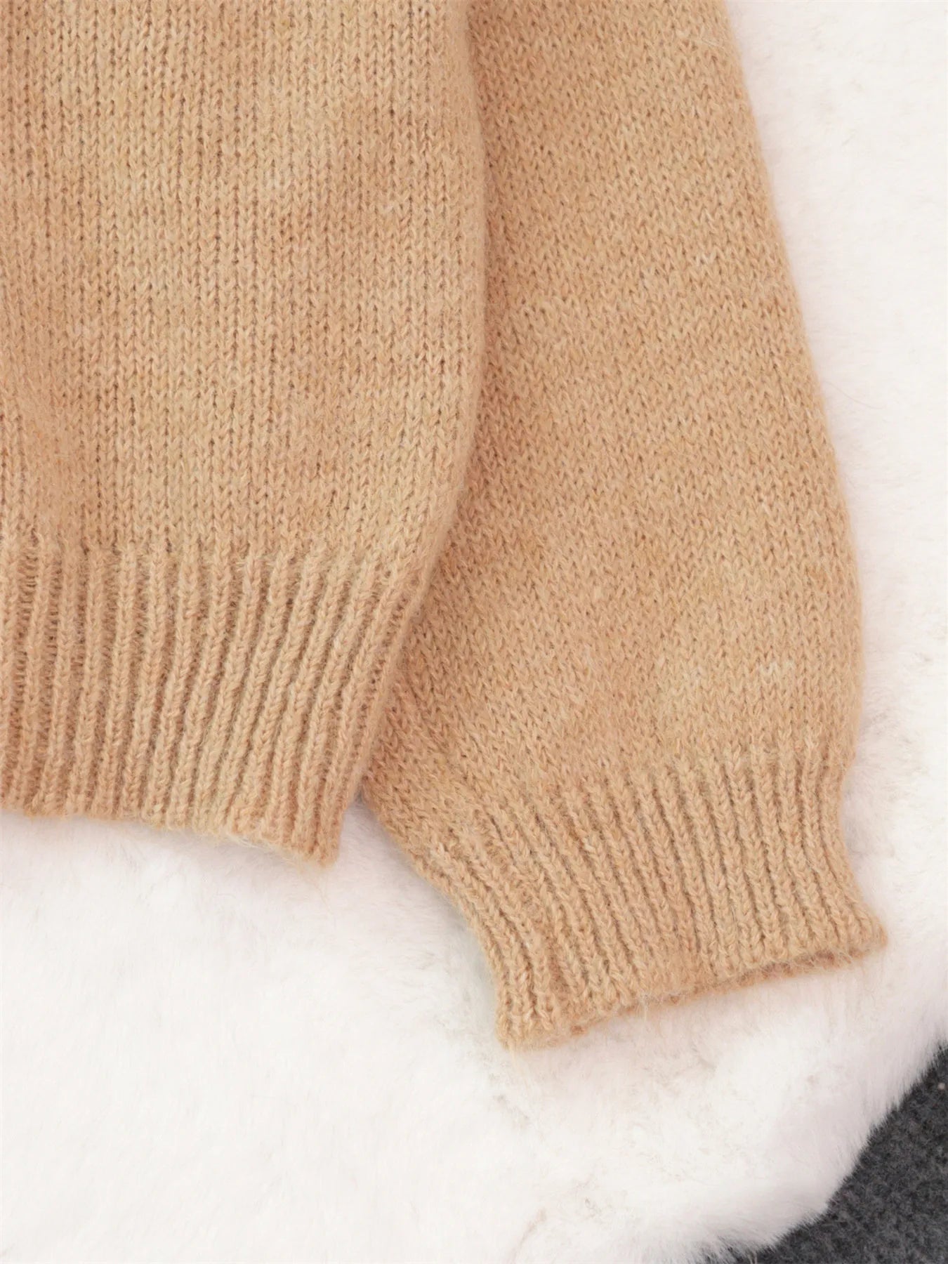 Khaki oversized knit sweater sleeve and ribbed cuff