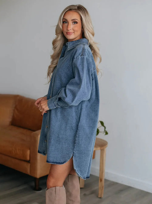 Medium-wash denim shirt dress with pointed collar, button placket, long sleeves, belt