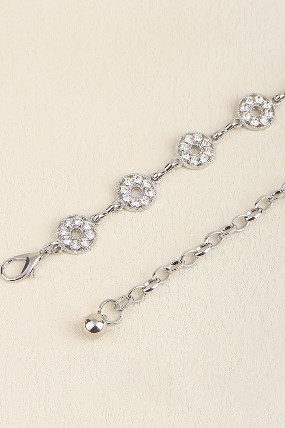 Silver rhinestone chain belt with round clustered links and clasp ends