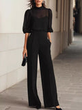 Black mock neck sheer puff-sleeve top with wide-leg pants set, tucked waist detail