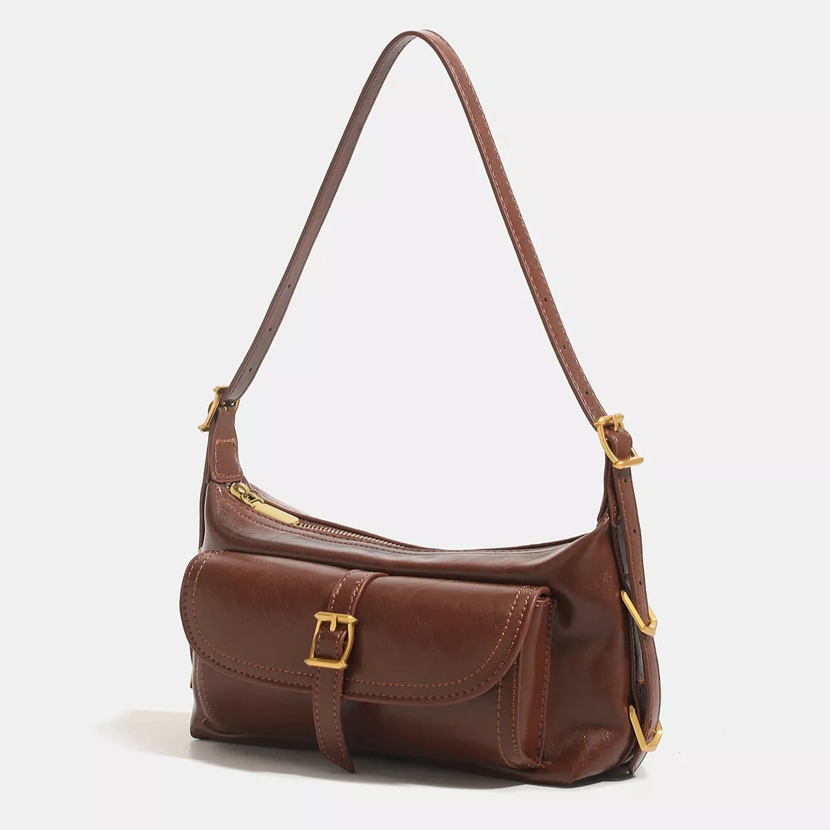 Caramel vegan leather shoulder bag with flap, gold-tone buckle, and adjustable shoulder strap