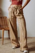 Tan wide-leg drawstring pants with side pockets, relaxed ankle length