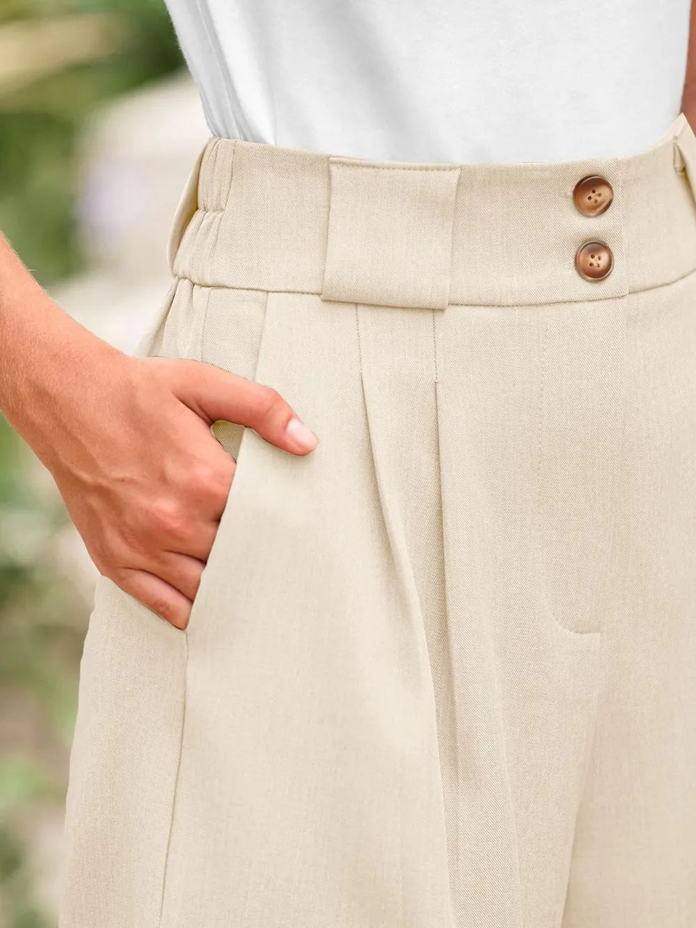 Cream high-rise shorts with wide waistband and two button closure