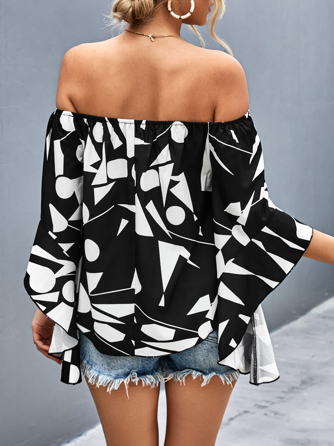 Back of off-shoulder bell sleeve blouse, black with white abstract print
