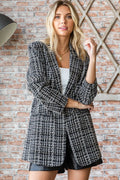 Black-and-white tweed one-button blazer with notch lapels and long sleeves