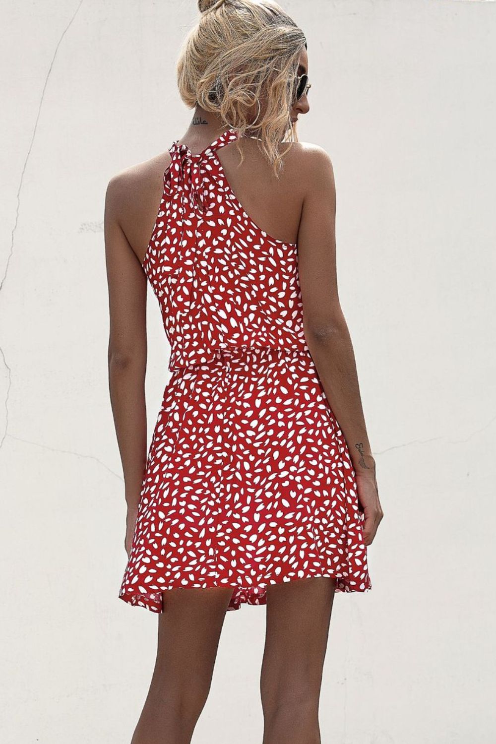 Deep red printed halter mini dress with open back and tie waist detail