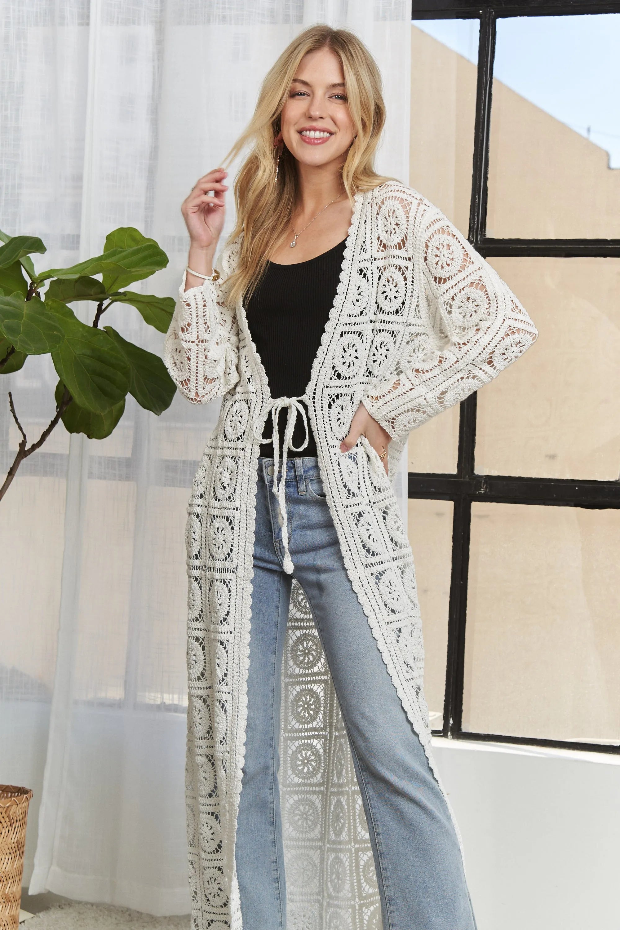 Ivory crochet long cardigan featuring open front, draped hem, and ornate square panels