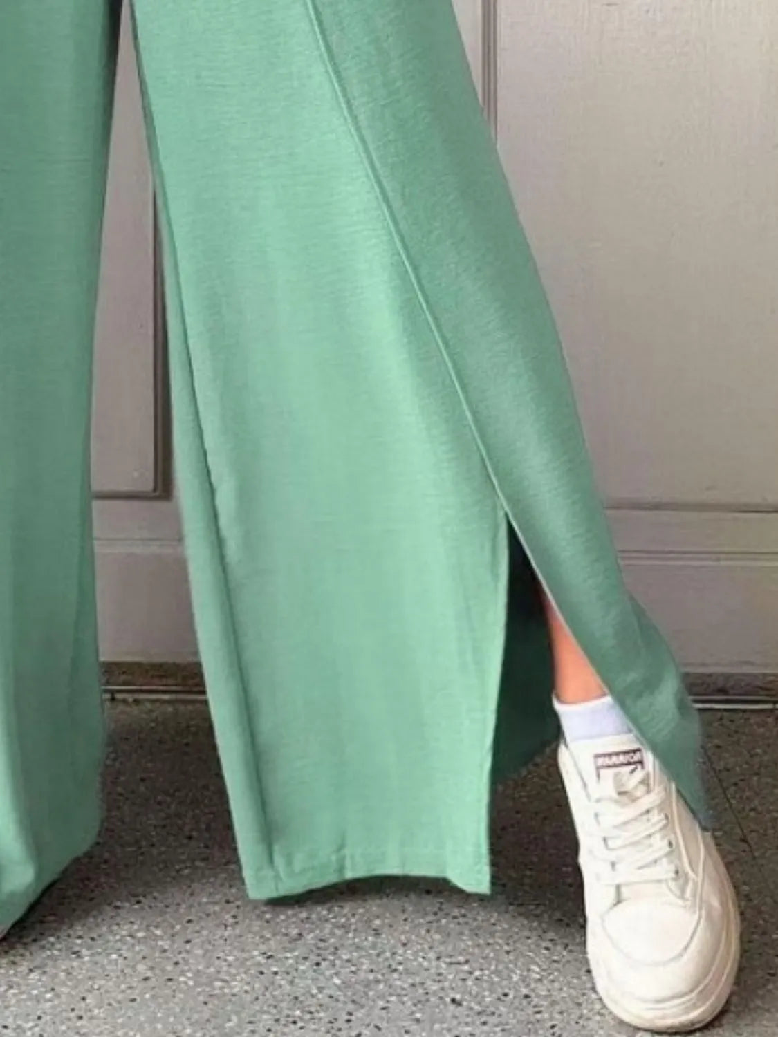Mint green slit wide-leg pants with side slit and flowing wide-leg silhouette