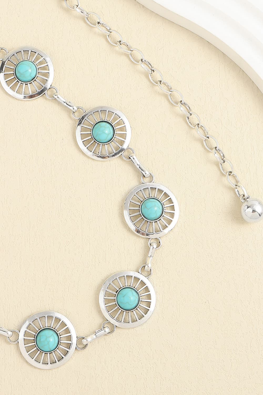 Turquoise round disk belt with linked segments and silver-toned chain drop