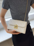 Beige quilted shoulder bag with gold chain strap and bee clasp, flap front