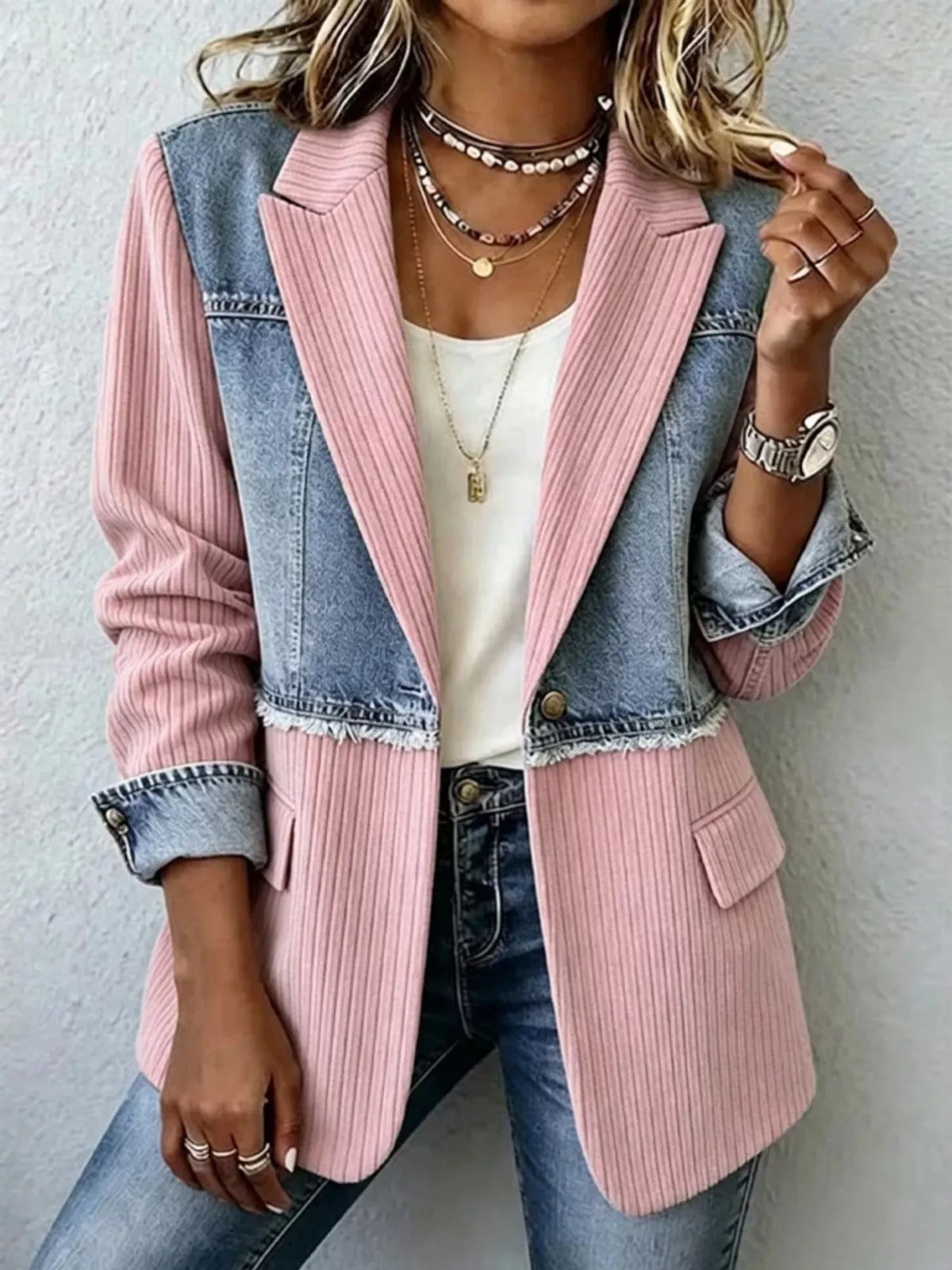 Blush pink and blue denim patchwork blazer with ribbed panels and flap pockets.