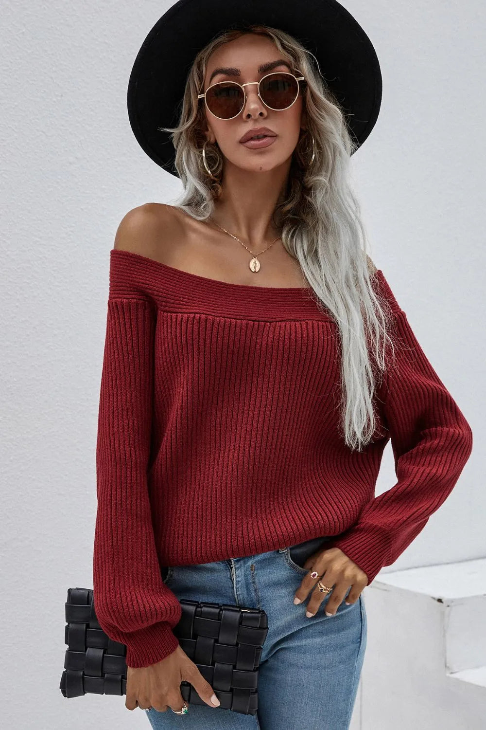 Burgundy off-shoulder rib-knit sweater with long sleeves and ribbed texture.