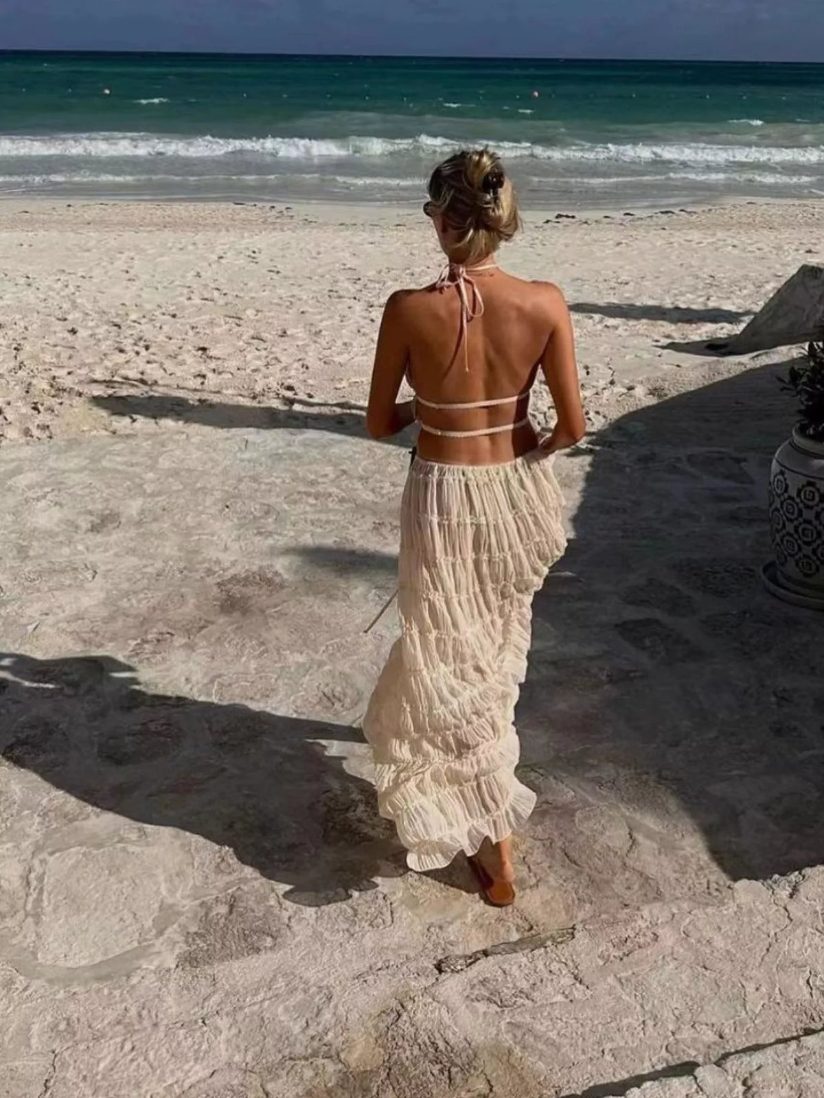 Milky white halter crop top and maxi skirt set with open back and ruffle tiers