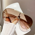 Gold-tone aviator sunglasses with gradient brown lenses and thin metal frame