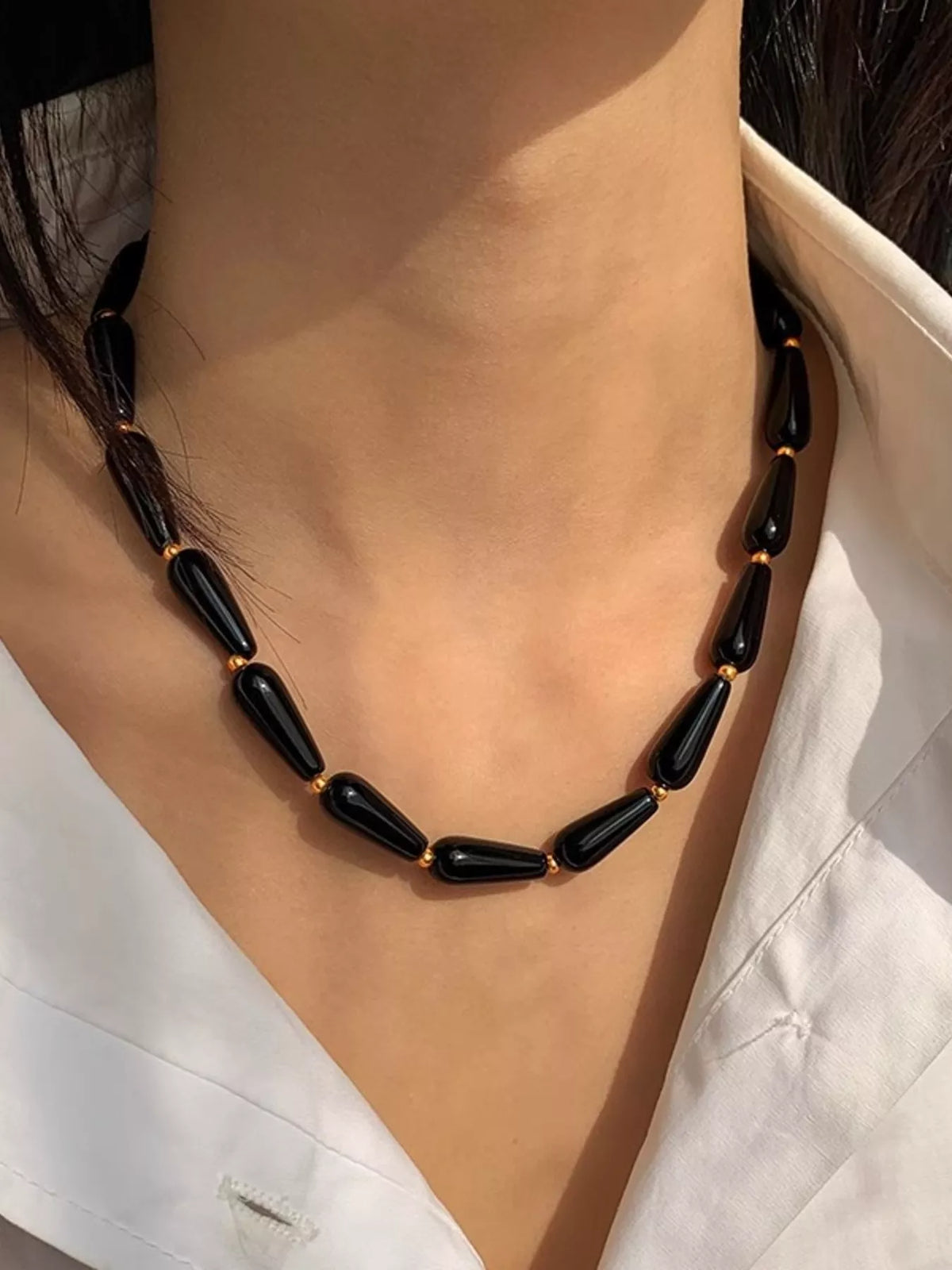 Black teardrop agate bead necklace with gold chain links, adjustable fit