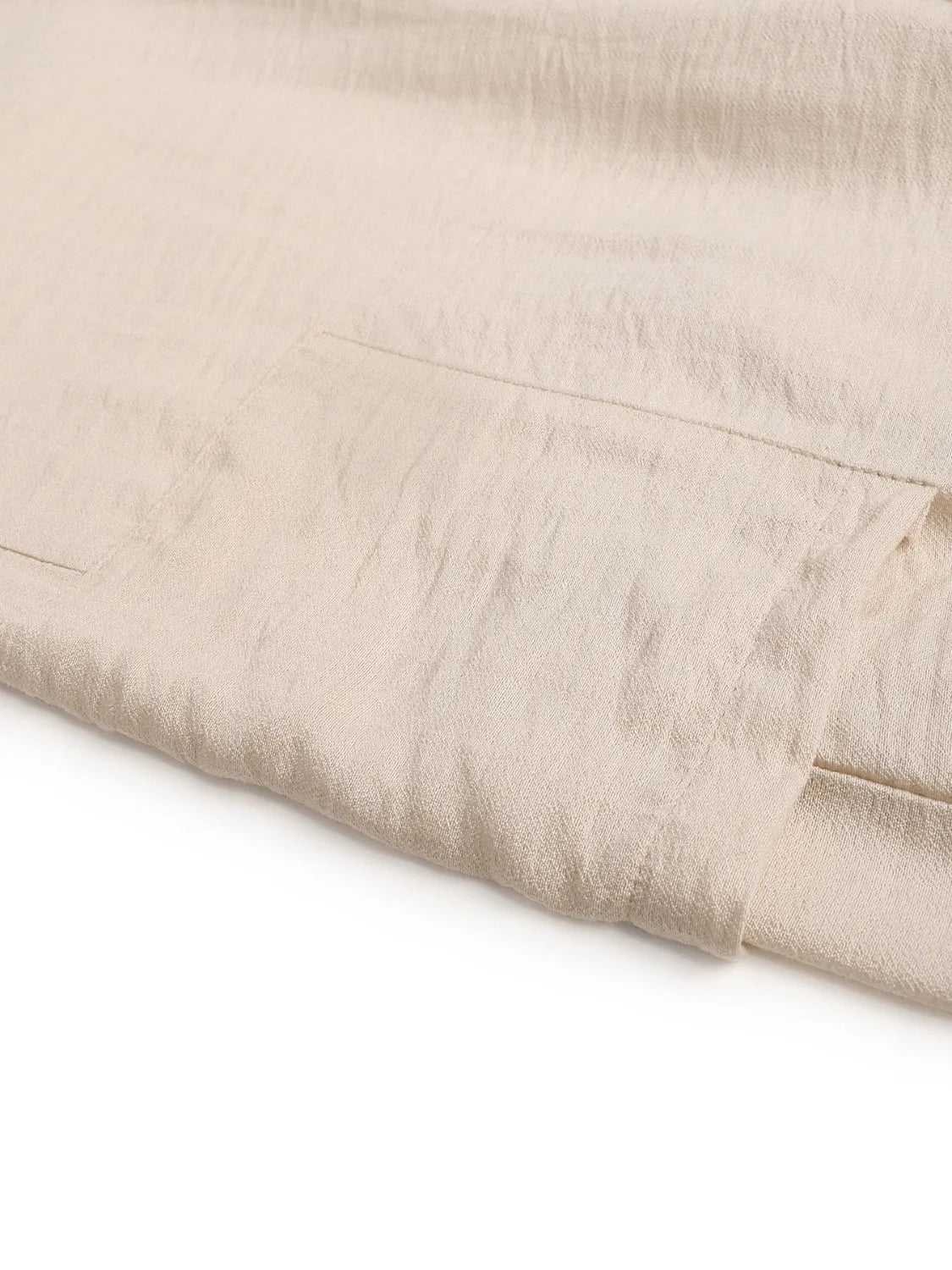 Cream woven pant fabric with subtle texture and side seam detail