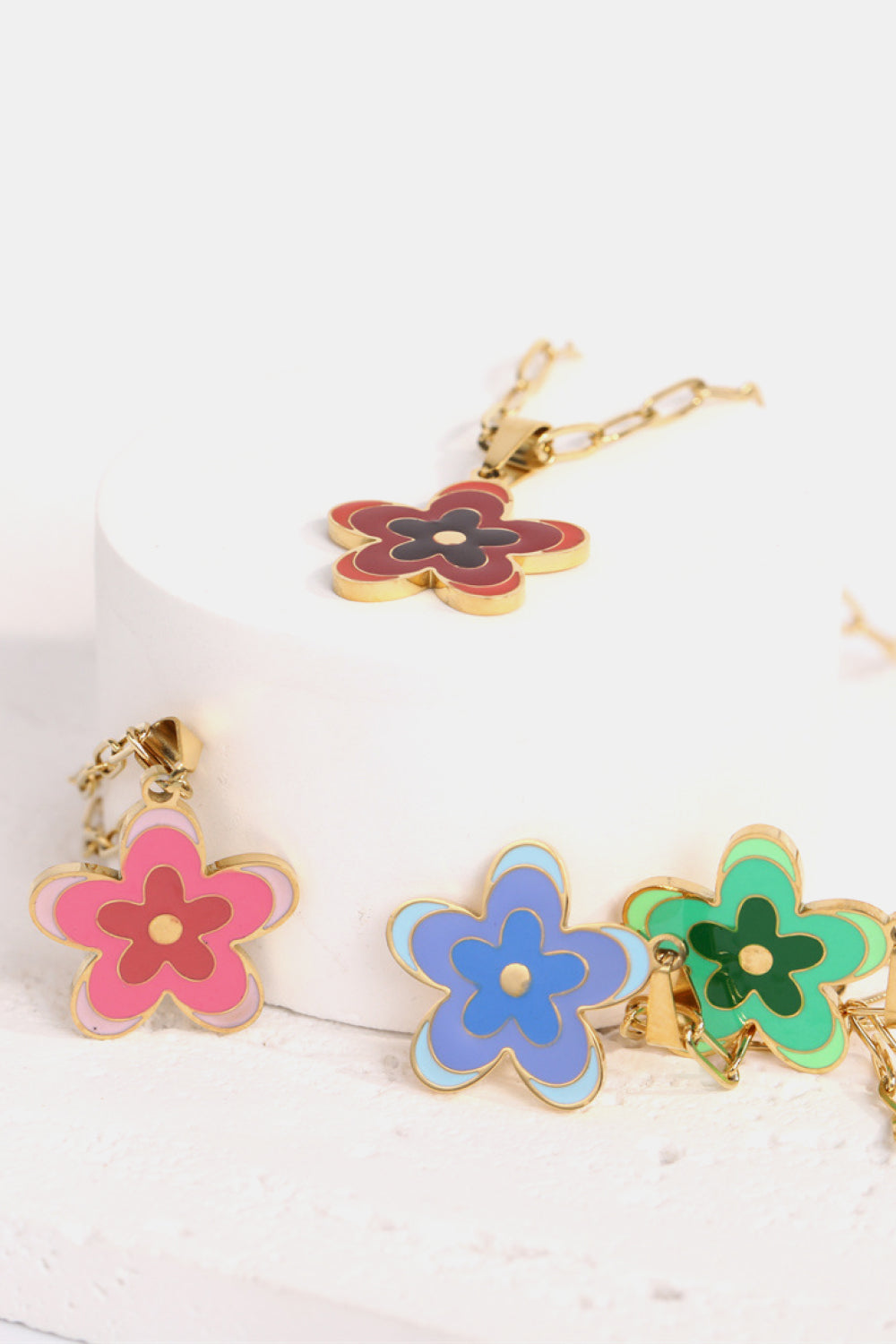 Flower pendant necklace with gold chain and pink, blue, and green enamel flower pendants