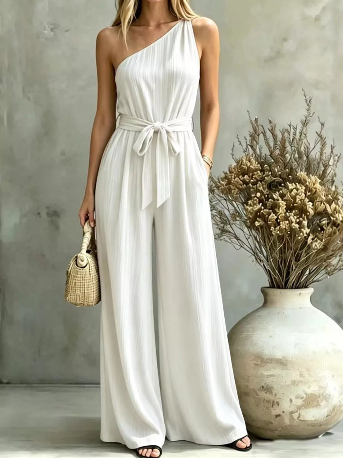 One-shoulder pleated wide-leg jumpsuit in white with self-tie waist and wide pants