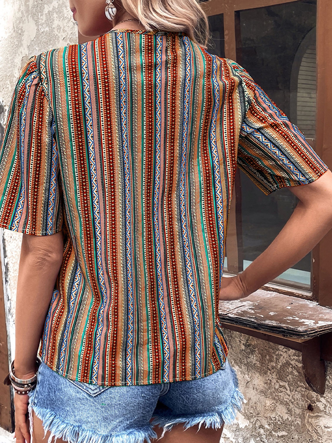 Shiny printed v-neck button-up short sleeve top, back view, red and teal vertical stripe