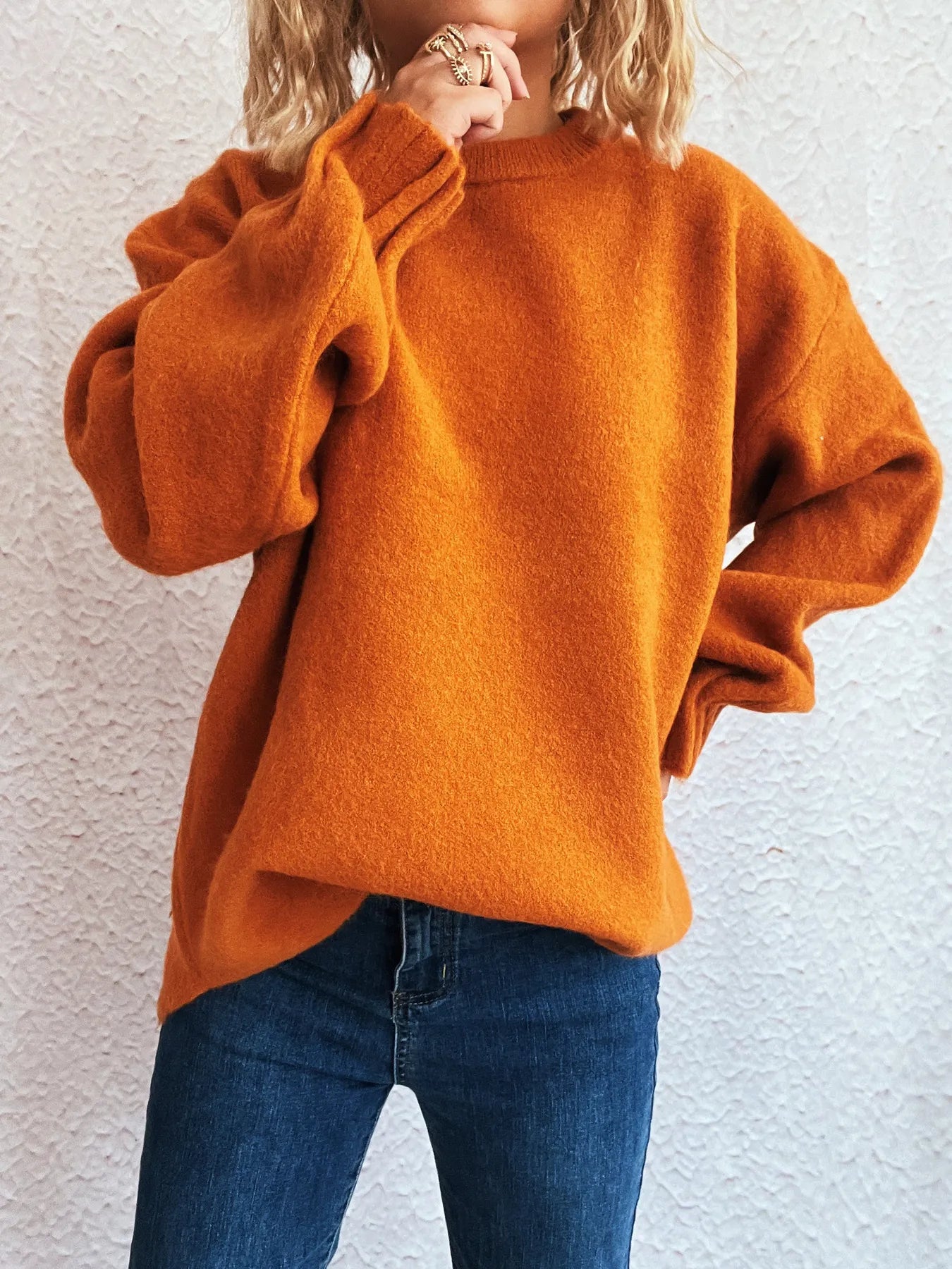 Dropped-shoulder sweater, rust orange, round neckline, long sleeves, side hand pose