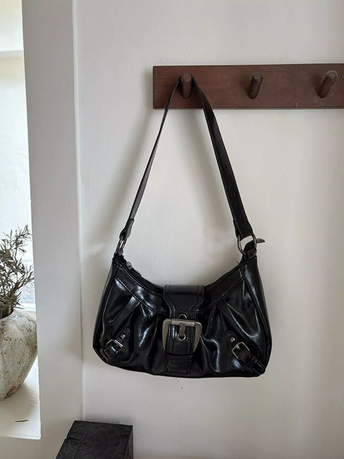 Black ruched shoulder bag with front buckle and adjustable shoulder strap