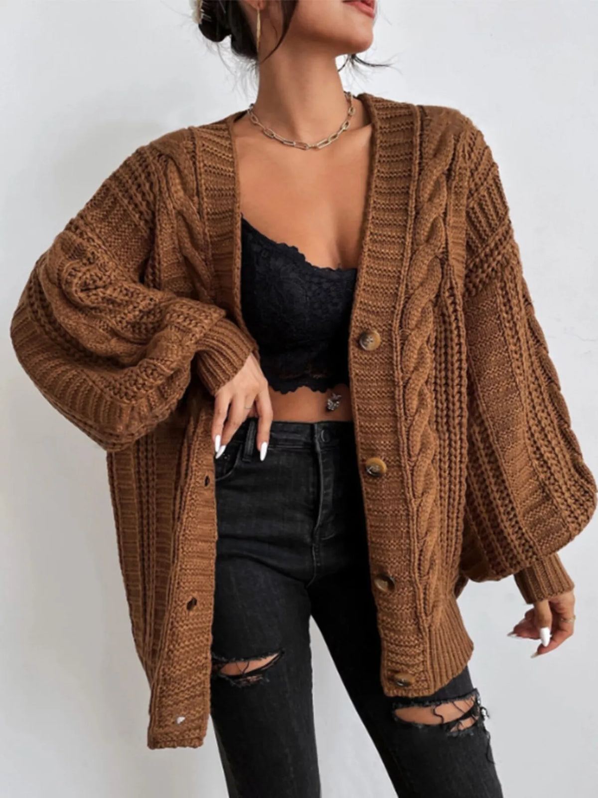 Brown oversized cable-knit V-neck button cardigan with long sleeves and ribbed trim