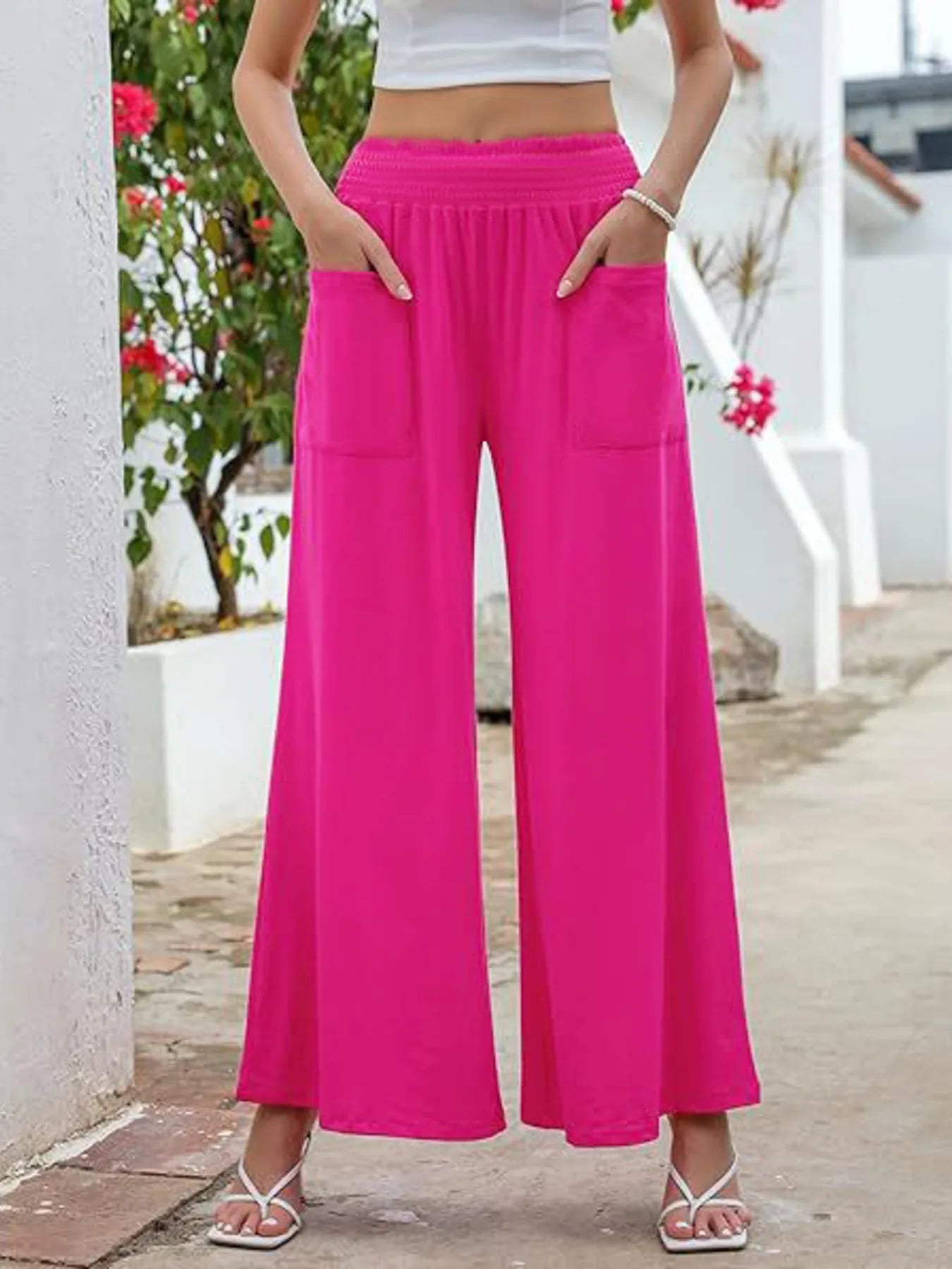Hot pink high-waisted wide-leg pants with elastic waistband and side pockets
