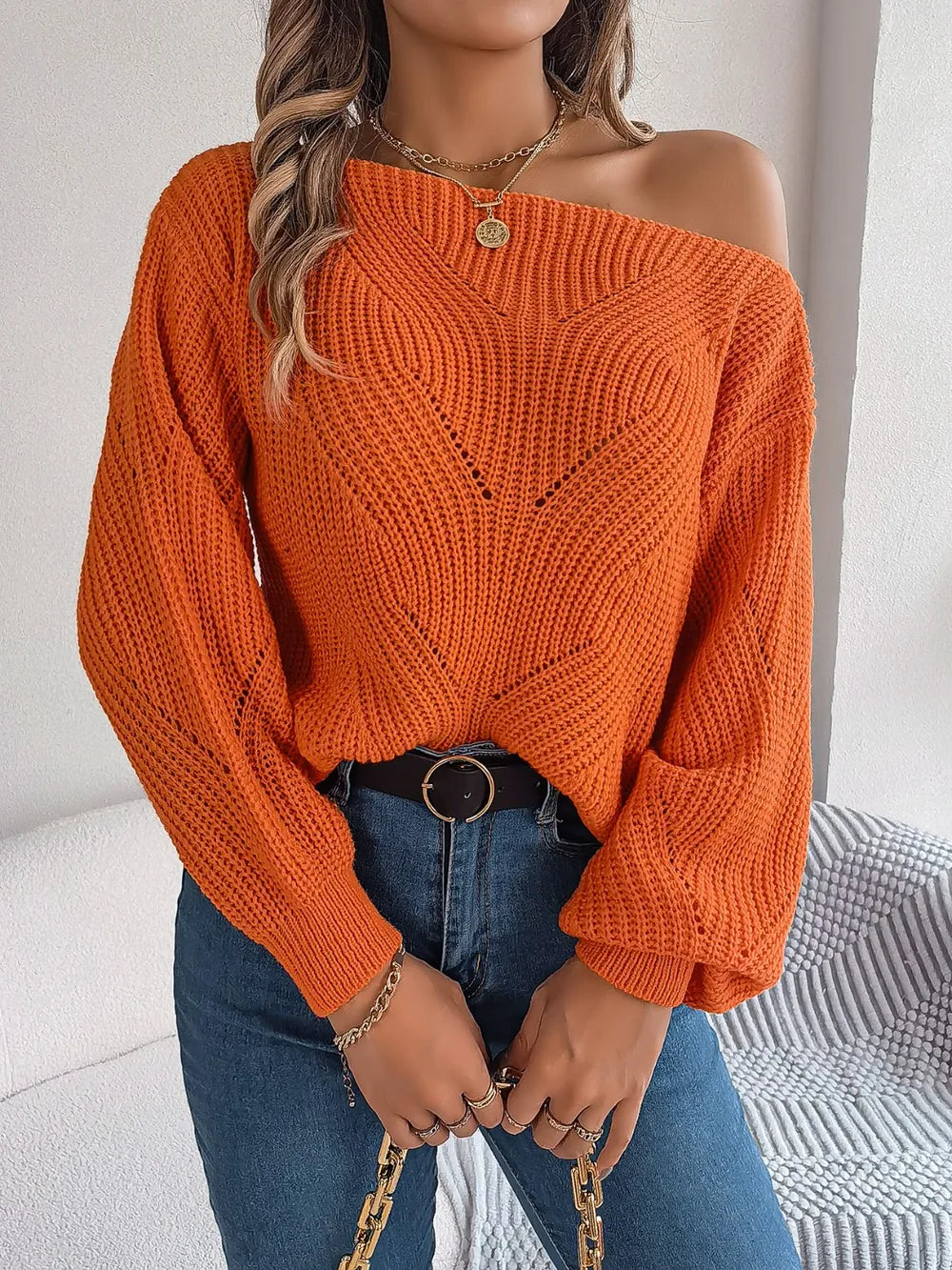 Openwork long-sleeve sweater in rust orange, shoulder-baring knit with V yoke