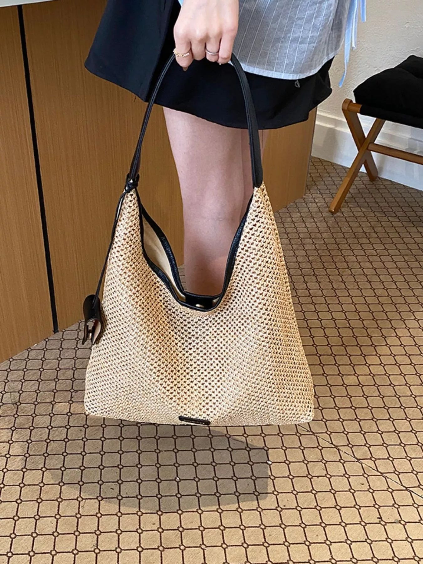 Camel woven straw shoulder bag with black handles and front patch pocket