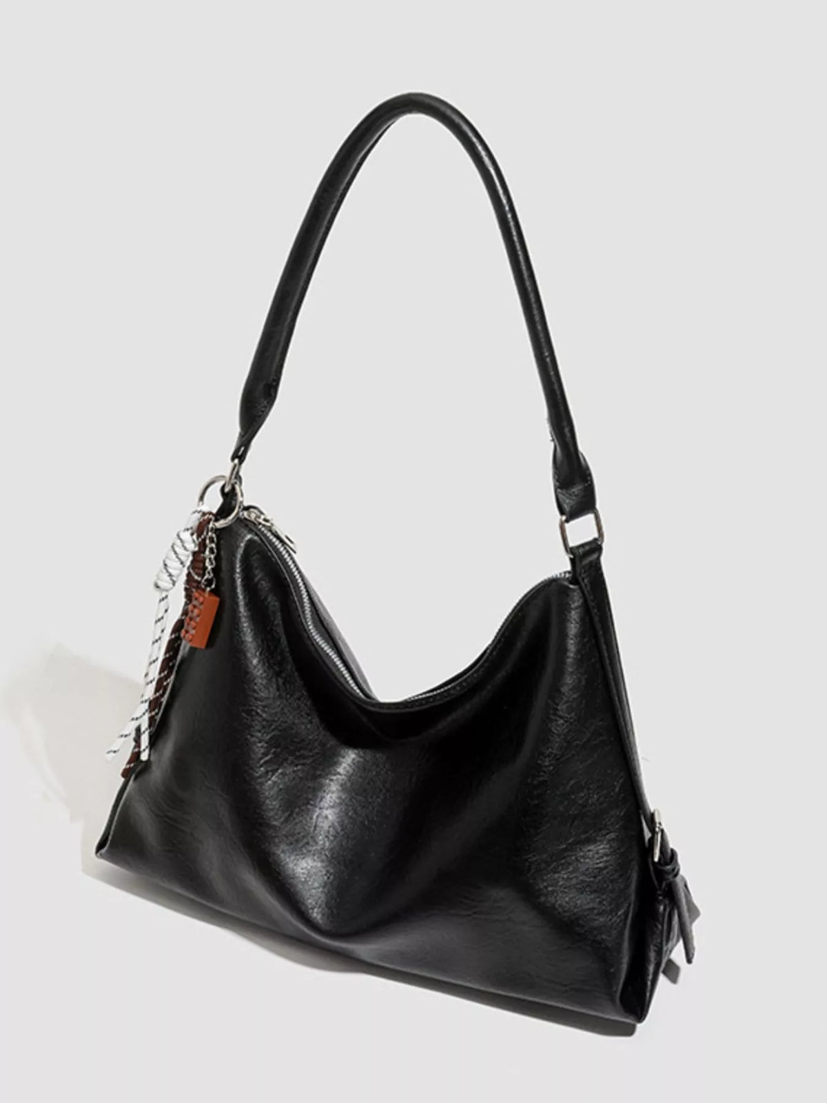 Black hobo shoulder bag with curved handle, braided strap accent, and side buckles
