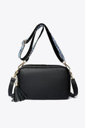 PU leather tassel crossbody bag, black with tassel detail, gold-tone hardware, and handles