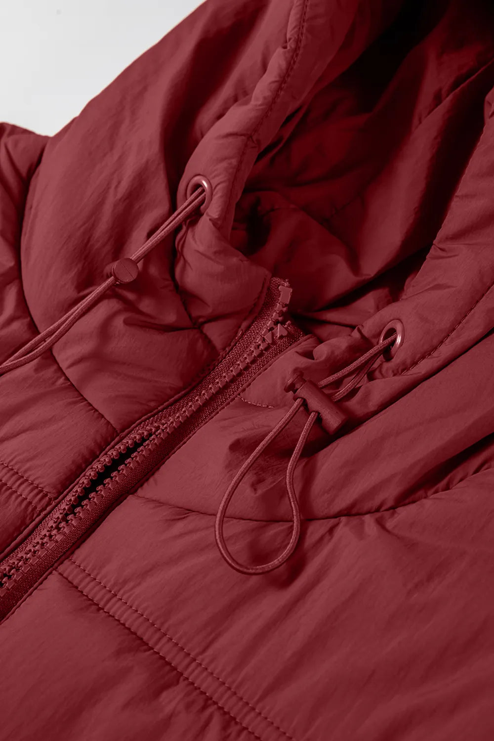 Burgundy hooded vest coat front detail with zipper, drawcord loops, and metal pulls