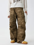 Tan camouflage cargo pants with side flap pockets and relaxed legs