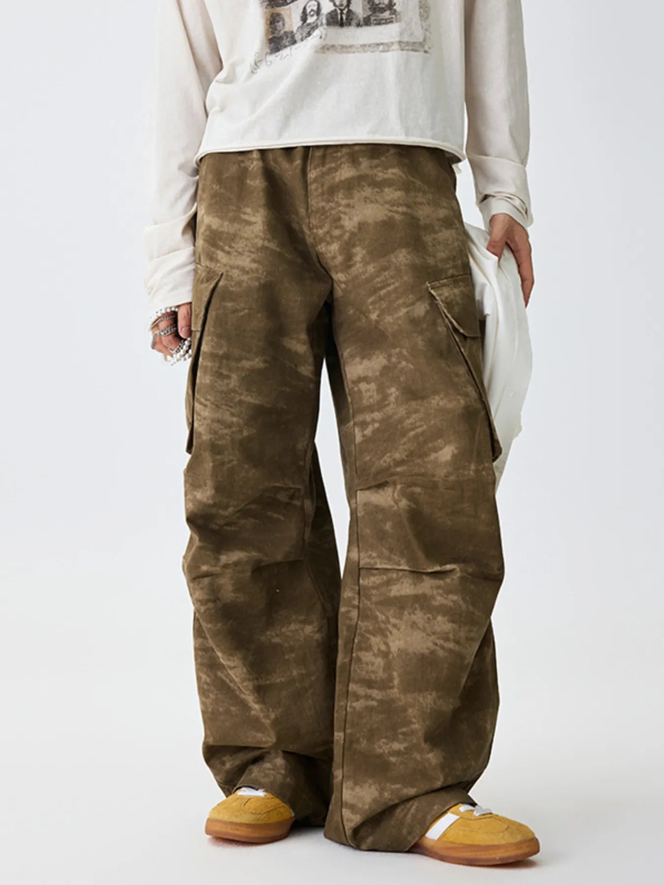 Tan camouflage cargo pants with side flap pockets and relaxed legs