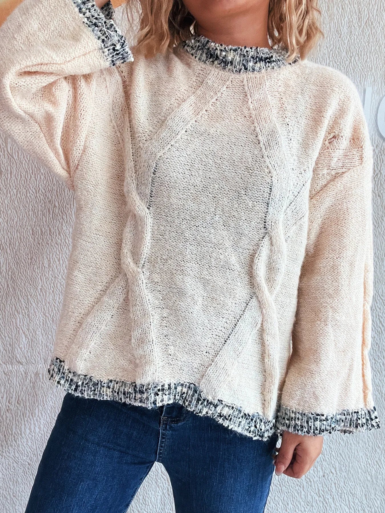 Apricot round-neck sweater with contrast trim on neckline and sleeve cuffs